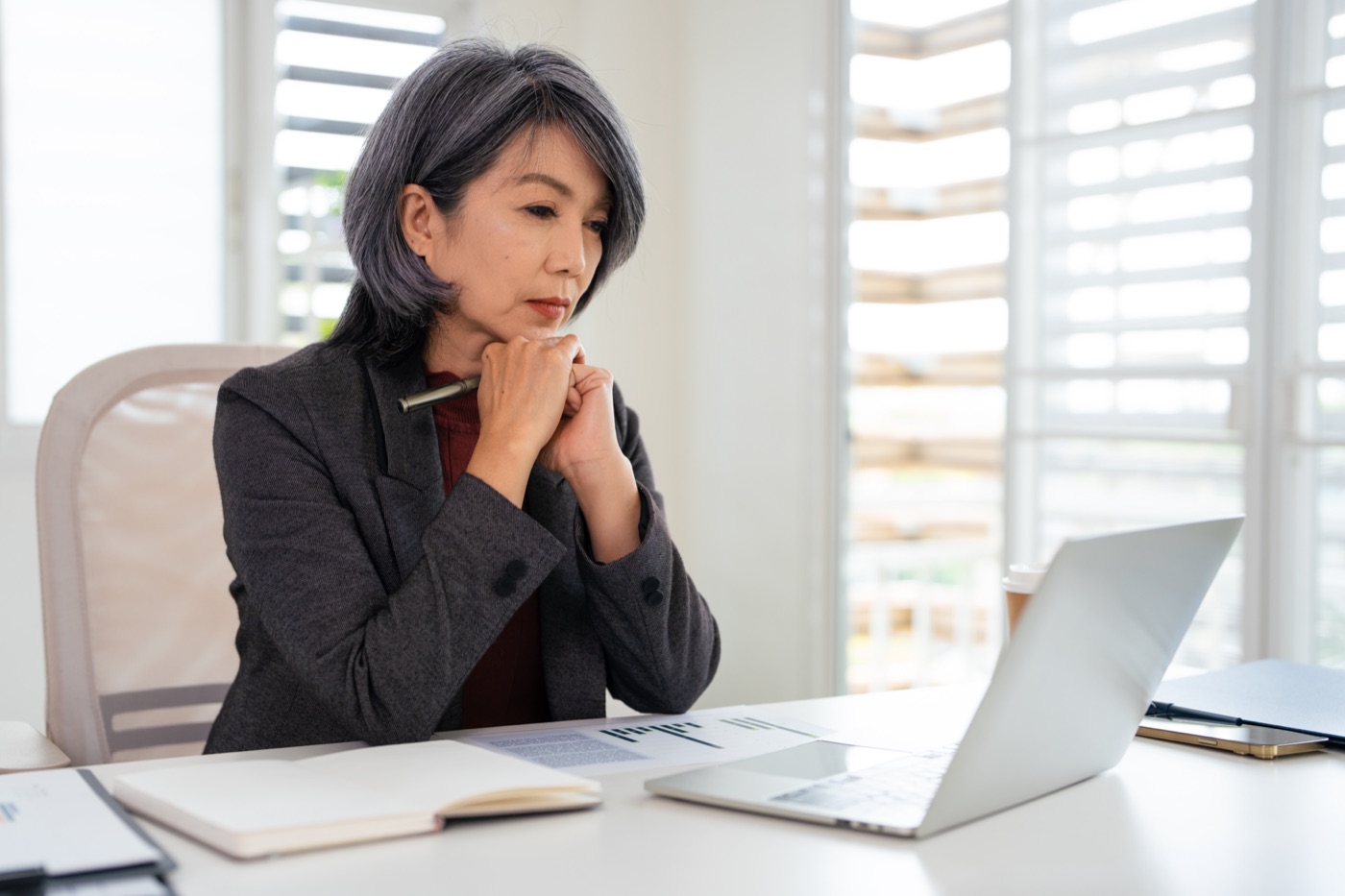 Business owner weighing her options at her desk